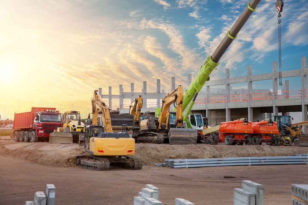 Construction site with several industrial machines and equipment.