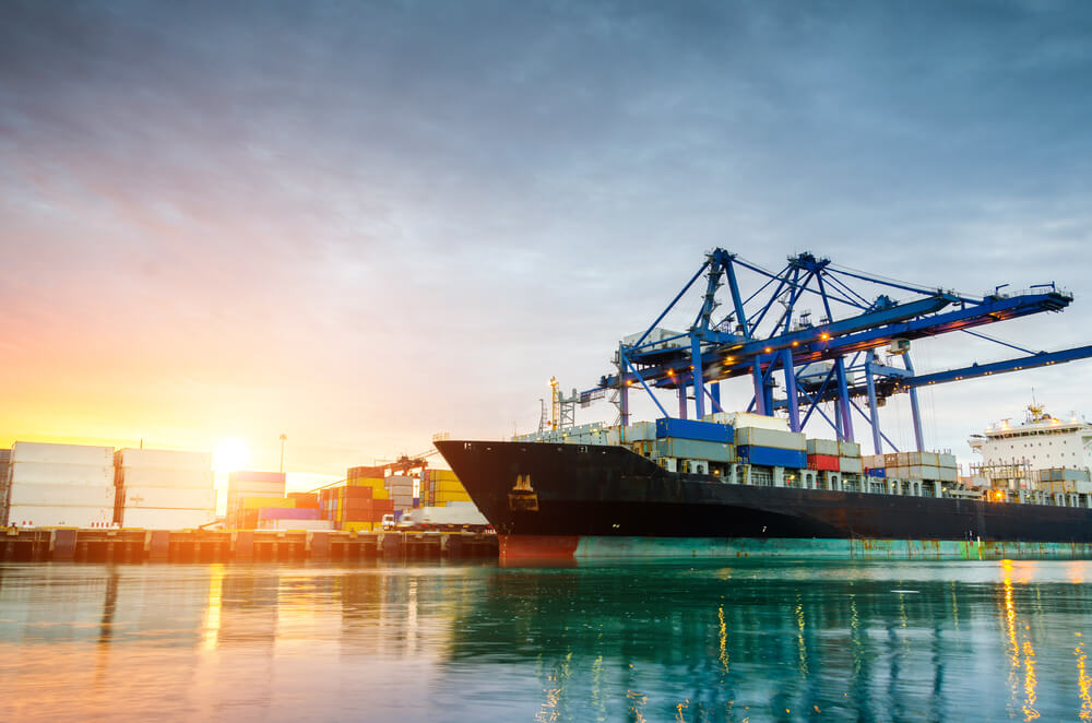 Docked cargo ship at a port with shipping containers 