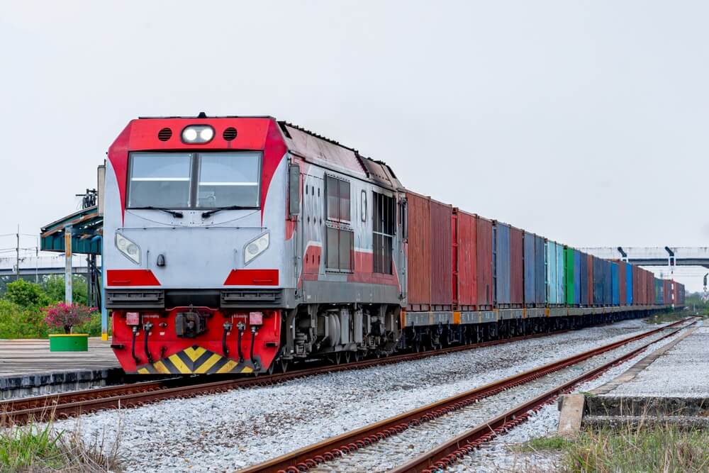 Freight rain with several carriages on railway track.