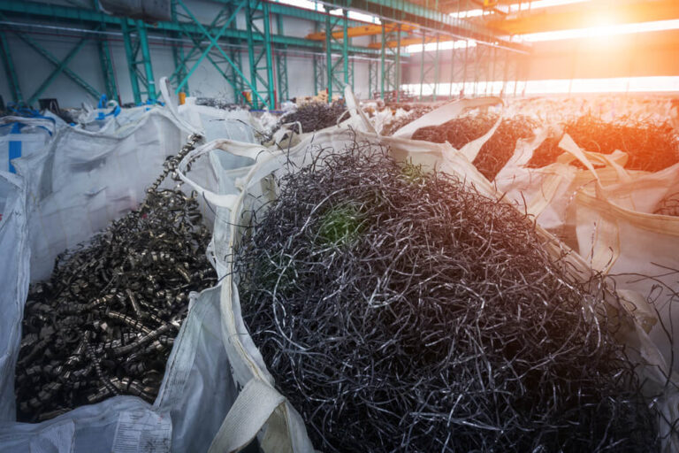 Bags of sorted metal at a waste centre.