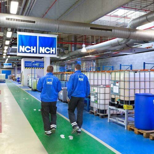 Two NCH employees walking through the manufacturing plant in the Czech Republic.